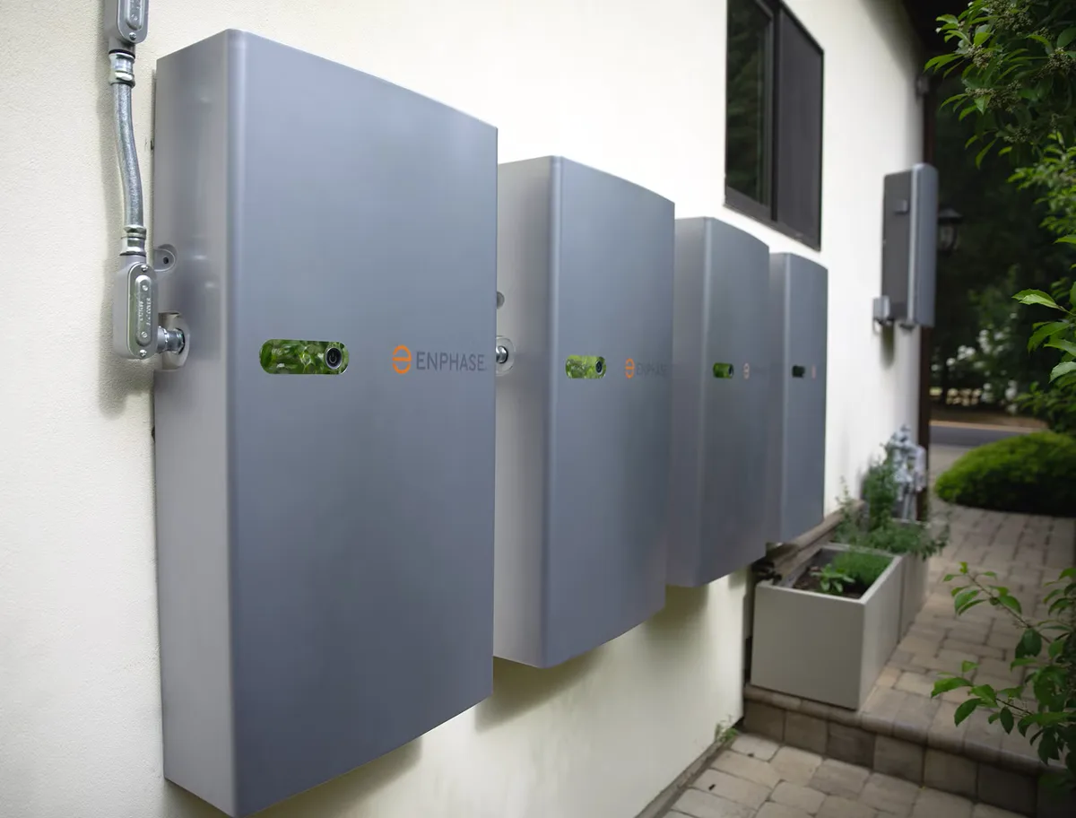 A bank of home batteries mounted on an exterior wall