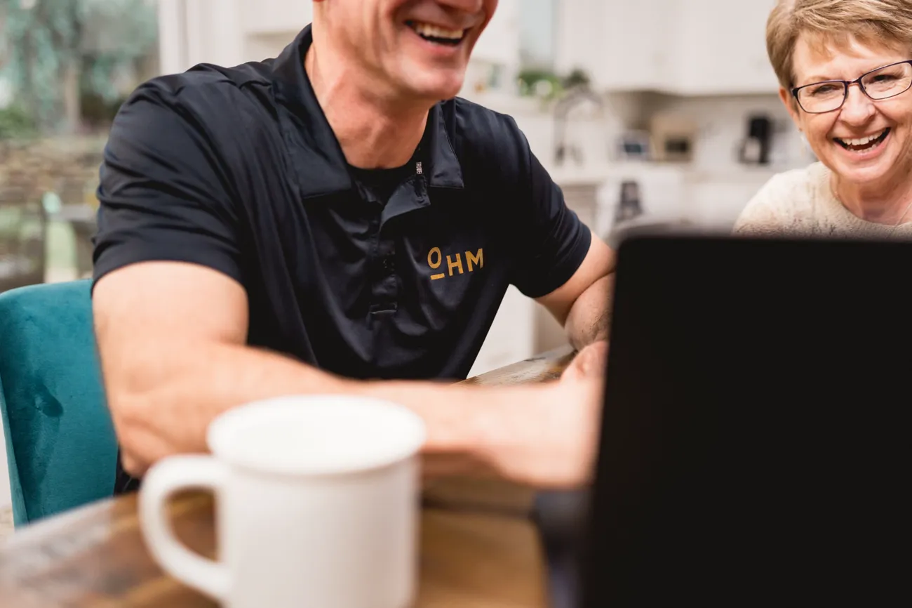 An OHM home energy pro going through an audit with a homeowner