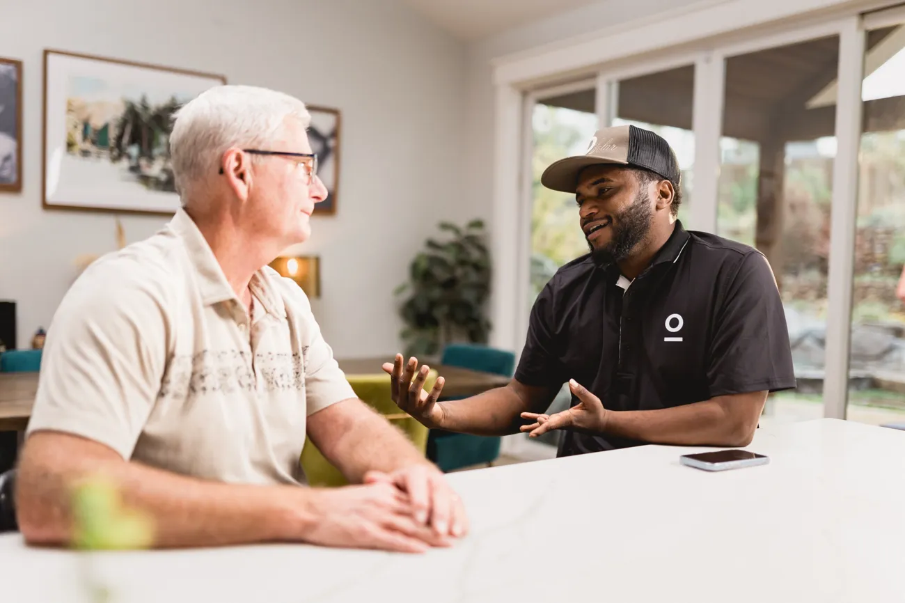 An OHM home energy pro comparing options with a homeowner