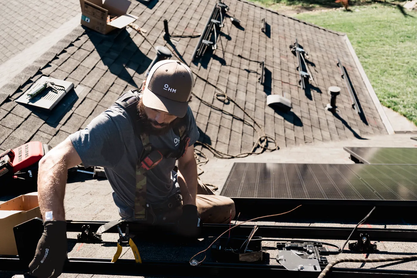 An OHM technician working on a rooftop array