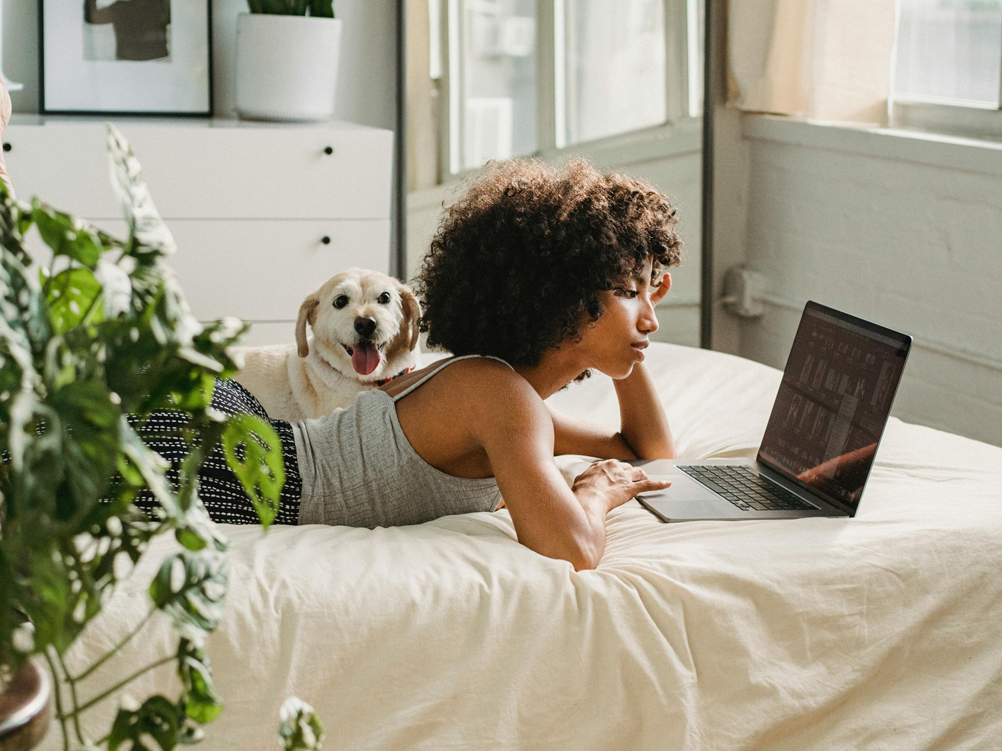 Homeowner using solar power to power her laptop